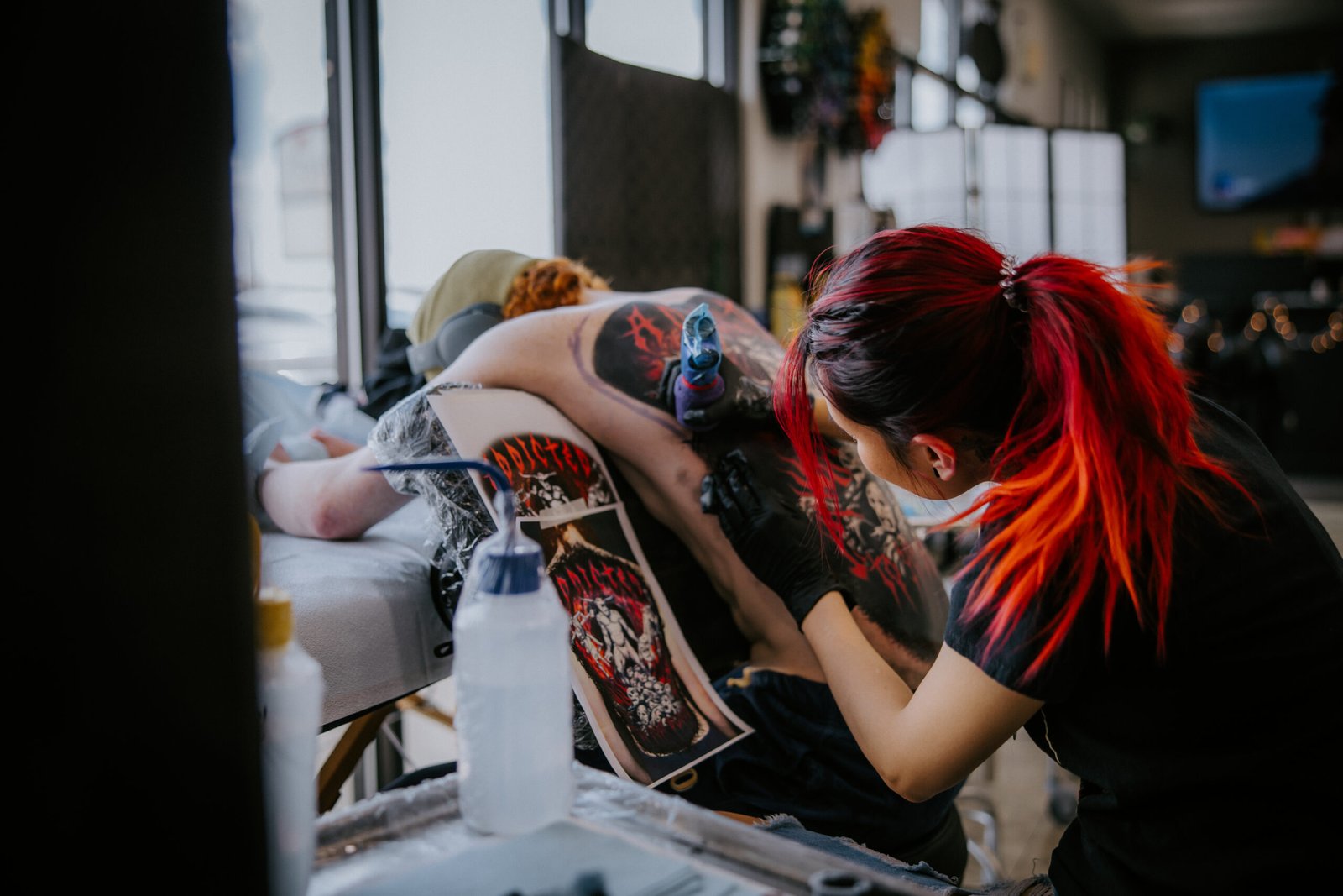 Tattoo Artist Mia working on a Backpiece
