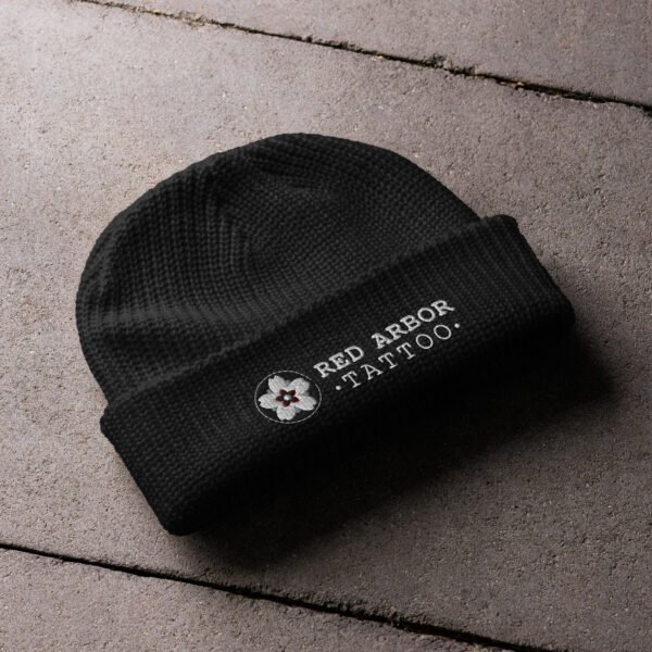 Red Arbor Fisherman Beanie – thick ribbed black knit hat with embroidered logo folded at cuff.